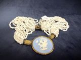 a close up of a necklace with a picture of a person on it