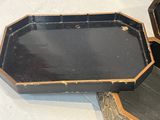 a black and gold tray sitting on top of a table