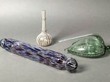 three glass objects on the table next to each other