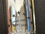 a silver lighter with stars on it on a black surface