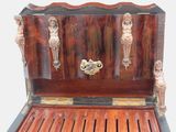 a wooden chest with carvings on the front and sides