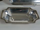 two silver plate dishes and a silver tray on a white table