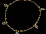 a gold bracelet with blue stones