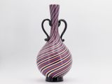 purple and black striped vase on black stand against a white background