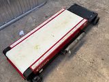a red and white mattress sitting on the ground