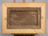 an old wooden easel with a painting on top of it