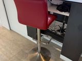 a desk with two red chairs and a computer on it