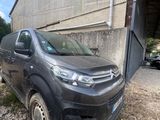 a grey van parked in front of a building next to a building
