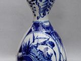 a blue and white vase with a woman on it