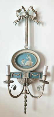 a wall sconce with a picture of a man on it