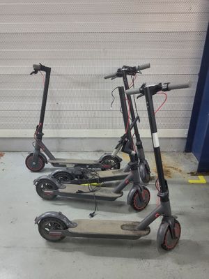 two scooters that are parked in a garage