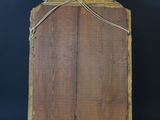 an old wooden easel with a rope around it on a black background
