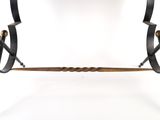 an iron and wood table with a black top and legs
