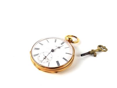 a gold pocket watch with a key attached to it
