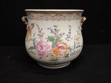 a vase with flowers painted on it sitting on a table