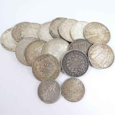 a pile of coins sitting on a white surface