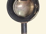 a metal object that is hanging from a hook