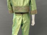 a mannequin wearing a green suit with gold embroiderys