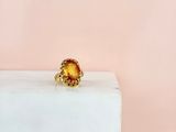un gros plan d'une bague en or sertie d'une citrine au centre