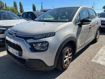 une Citroën argentée garée sur un parking à côté d'autres voitures
