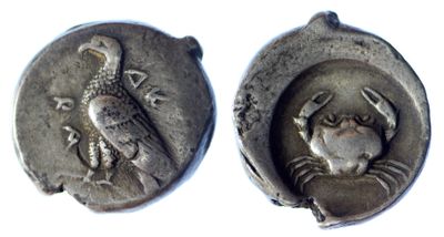 two ancient silver coins with a bird and a bird on them
