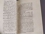 someone is holding a book open to a page with an image of a clock on it