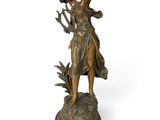 bronze statue of a woman holding a bird on a wooden base