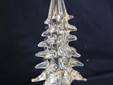 clear glass christmas tree on a clear base on a black background