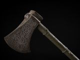 a close up of an old axe on a black background