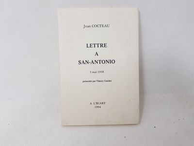 an old book sitting on top of a table next to a white wall