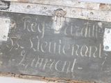a metal box with writing on it sitting on a table