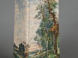 a vase with a painting on it sitting on a table