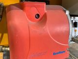 a red machine that is sitting on the ground