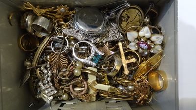 a box filled with lots of gold and silver jewelry
