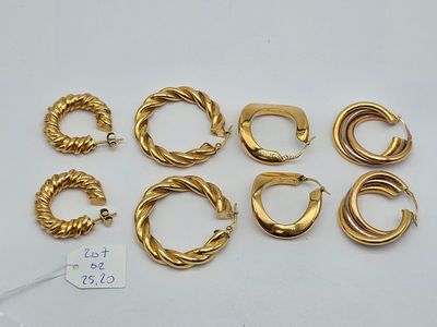 six pairs of gold hoop earrings and a pair of gold hoop earrings