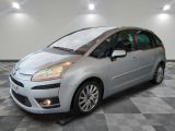 a silver citrole parked on a checkered floor in a garage