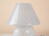 a white lamp that is sitting on a table