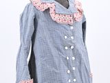 blue and white gingham dress with pink ruffles on a mannequin base