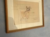 a picture of a dog that is hanging on the wall