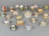 many different types of tea cups and saucers on the table