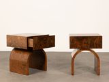 two small wooden tables sitting on top of a cement floor
