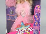 doll in a box with a pink dress and pink hair