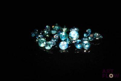 some very pretty blue and white diamonds on a black surface