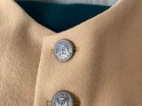 a close up of a coat with buttons on it
