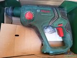 a green and red cordless drill in a box