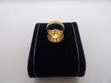 a close up of a gold ring on a black velvet bag