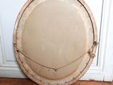 a round mirror sitting on the floor next to a door