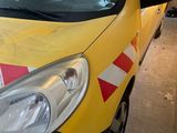 a yellow van with red and white stripes parked in a garage