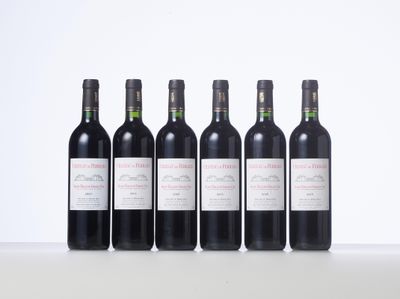 six bottles of wine are lined up on a table
