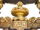 a gold table with a bowl on top of it